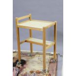 A beech & laminate two-tier tea trolley on square legs with castors 21¾” wide; & two wall