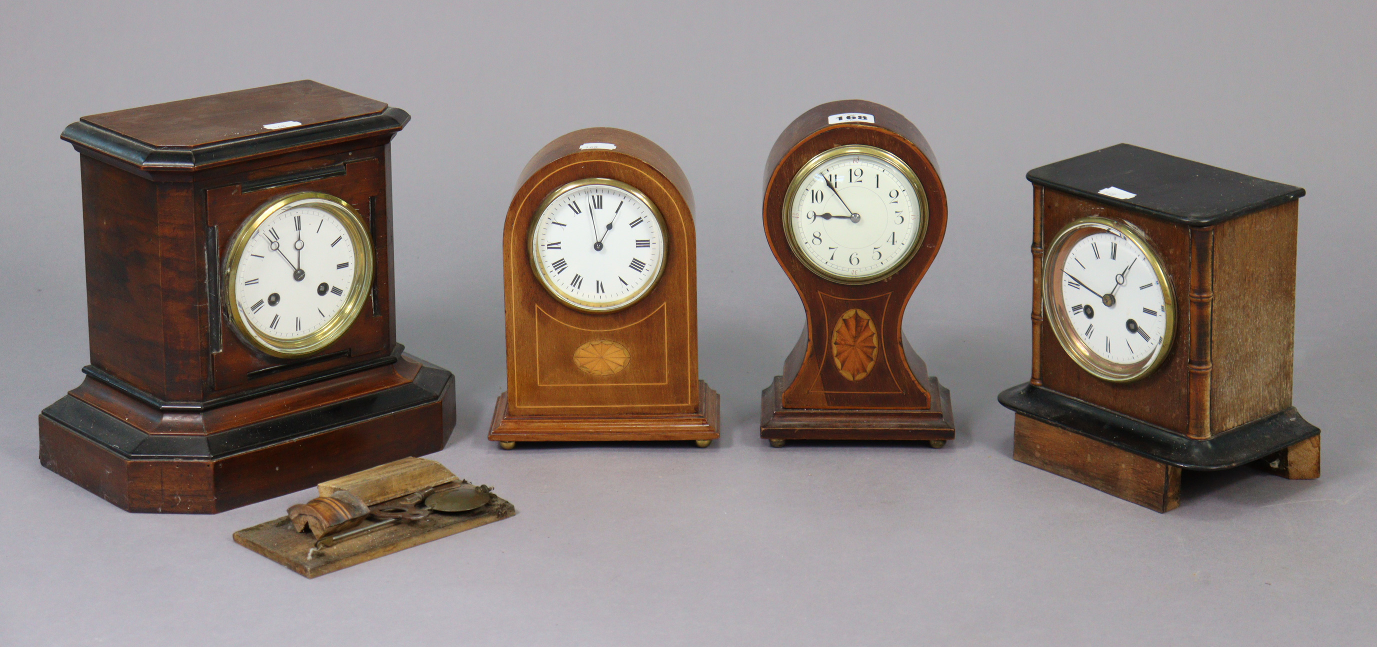 Two Edwardian mantel timepieces each in an inlaid-mahogany case; together with two Edwardian