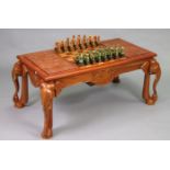 A Sri Lankan carved hardwood low occasional games table, having elephant design to the reversible