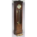 A 1950’s longcase clock with a silvered dial, chiming movement, in an oak case enclosed by a