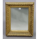 A gilt frame rectangular wall mirror with a raised scroll border, 24” x 19½”, & a copper engraved