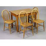 A set of four spindle-back kitchen chairs with hard seats, & on round tapered legs with spindle