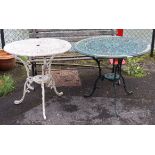 A white painted aluminium garden table with a pierced scroll circular top, & on three shaped legs,