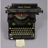 A vintage Smith Premier typewriter with cover; a gent’s walking cane; a vintage petrol can, etc.