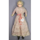 A vintage wax-head girl doll with blue open eyes, composition limbs, & stuffed body, 24½” tall,