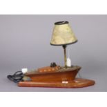 A wooden novelty table lamp base in the form of a boat, 17” wide, with shade.