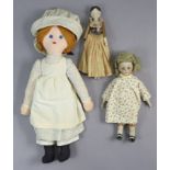 A Victorian wooden peg doll, 10” high; together with two other dolls.