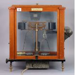 A vintage “Release O-Matic” laboratory balance by L. Oertling of London, in a mahogany case.