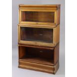 A Globe Wernicke mahogany three-tier sectional bookcase each tier enclosed by a glazed door, & on