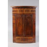 An early 19th century mahogany large corner cabinet, with satinwood crossbanding & applied