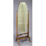 A mahogany-frame oval cheval mirror on square tapered supports & cabriole legs, 20¼” wide x 62¼”