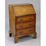 A 19th century inlaid-mahogany small bureau with a fitted interior enclosed by a fall-front above