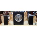 An Art Deco black slate and marble clock garniture comprising a mantle clock, 8¼” high; & a pair
