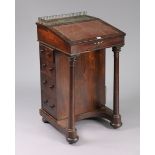 A 19th century rosewood davenport inset crimson leather to the hinged sloping-front, fitted four