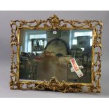 A 19th century-style gilt frame rectangular wall mirror having a pierced scroll border, 35” x 29” (