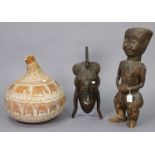 An ethnic carved wooden female sculpture, 23” high; a similar wall mask, 18” high; & a gourd bottle,