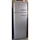 A Smeg upright fridge-freezer in a silvered-finish case, 23½” wide x 65¾” high.