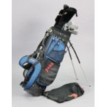 A matched set of golf clubs, with a golf club bag.