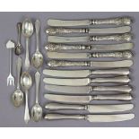 A set of six Edwardian tea knives, the loaded silver handles with embossed floral decoration,