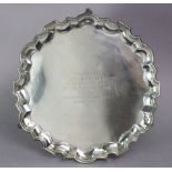 An Edwardian silver salver with raised pie-crust border, the centre with engraved inscription: “