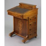 A Victorian inlaid rosewood davenport with a fitted interior enclosed by a sloping hinged lid, inset