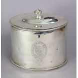 A George III silver oval straight-sided tea caddy with vase finial to the slightly domed hinged lid,