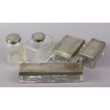 Three Victorian clear glass dressing case receptacles with engraved silver removable lids, London