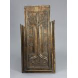 A 16th century carved oak pew-end, 32” x 15½”.