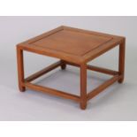 A 20th century Chinese hardwood square occasional table on square supports, 21” wide x 13 ½” high.