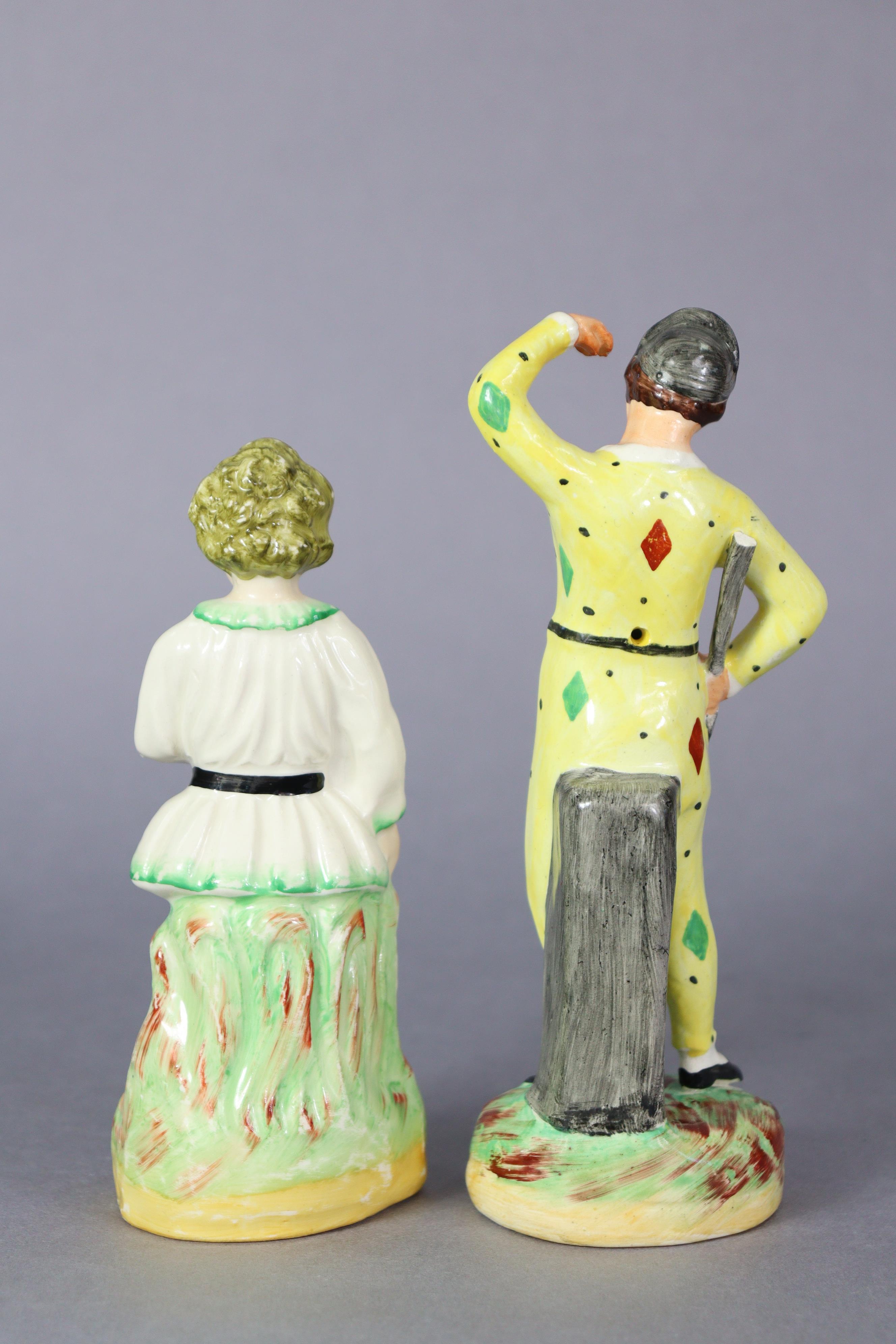 A 19th century Staffordshire pottery figure of a harlequin, & another of a cricketer, each stood - Image 3 of 4