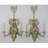 A pair of 19th century gilt-metal lyre-shaped wall sconces, each with three spiral-twist arms,