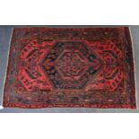A north west Persian Malaya rug of madder ground with repeating geometric floral designs