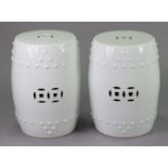 A pair of Chinese white-glazed porcelain garden seats, of barrel form with pierced sides, each