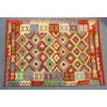 A Turkish Anatolian Kilim rug with multicoloured geometric designs, 81” long x 58” wide.