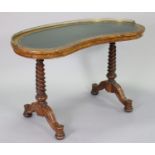 A Victorian walnut kidney-shaped writing table with a pierced brass gallery & gilt-tooled green