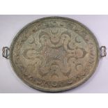 A late 19th/early 20th century Kashmiri pierced copper two-handled tray of oval shape, with crescent