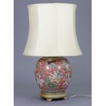 A Chinese porcelain pink-ground ginger jar/table lamp with decoration of swimming fish, 26” high