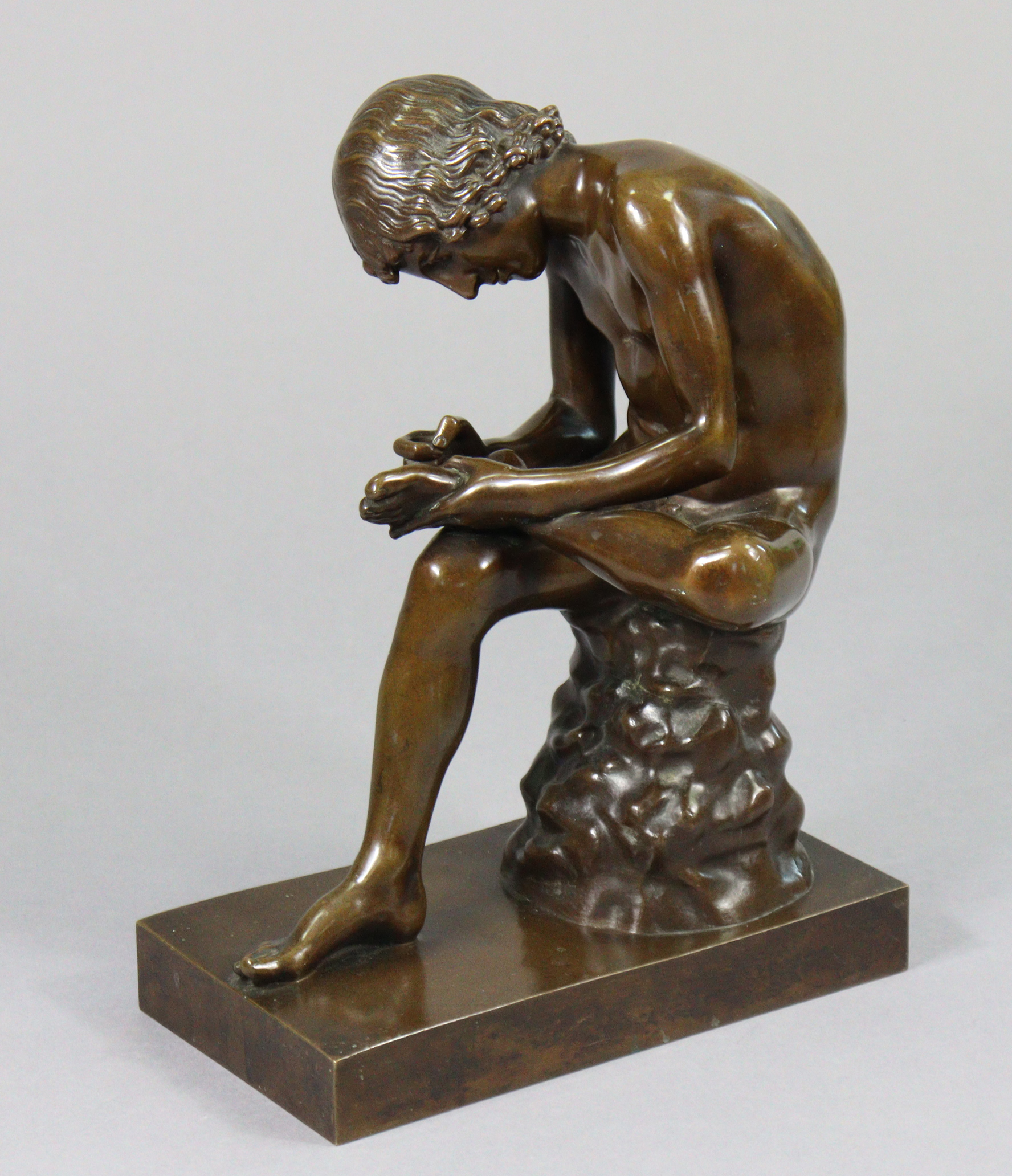 After FERDINAND BARBEDIENNE (1810-1892). A patinated bronze figure of the Spinario, or Boy with