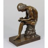 After FERDINAND BARBEDIENNE (1810-1892). A patinated bronze figure of the Spinario, or Boy with