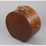 A late 19th/early 20th century tan leather & brass mounted circular hat box with embossed