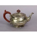 A George V silver teapot of round waisted form with turned scroll handle & turned wooden finial,