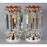 A pair of 19th century Bohemian glass candle lustres, each of trumpet shape with gilt rims &