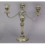 An Edwardian silver candelabrum with reeded borders to the round tapered column, two scroll arms