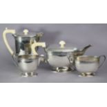 An Art Deco silver four-piece tea & coffee service of curved oblong form, each with narrow band of