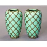 A pair of early-mid 20th century Japanese porcelain ovoid vases of pale green ground, each with