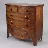 A 19th century mahogany bow-front chest fitted two short & three long graduated drawers with