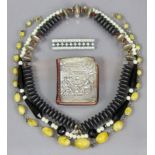 A modernist necklace of silvered & grey metallic discs; two other necklaces; a paste-set rectangular