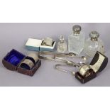 Three pairs of silver sugar tongs; four silver napkin rings; & three glass scent bottles with silver