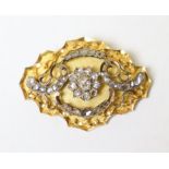 An antique gold & diamond oval brooch with irregular scalloped edge, set thirty seven graduated rose
