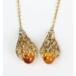 A Baccarat amber glass & silver-gilt necklace with heavy cage-work pendant either end; 100cm